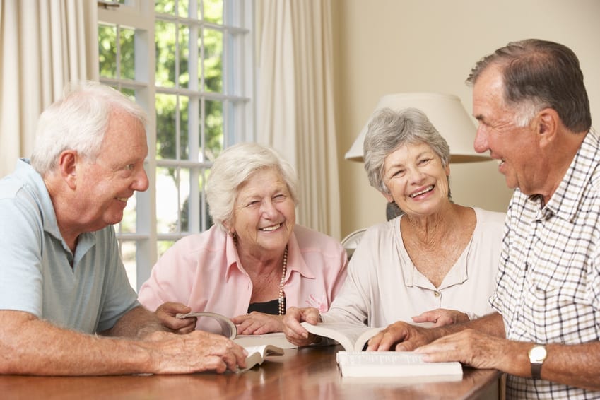 Group Of Senior Couples Attending Book Reading Group