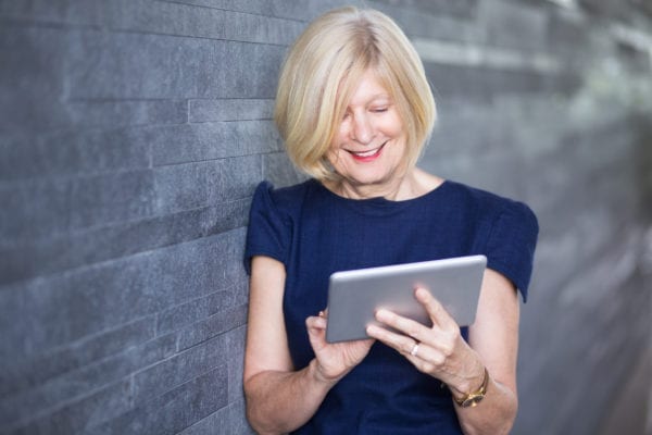 Happy Senior Businesswoman Using Digital Tablet